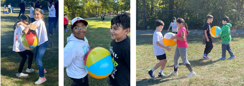 Students racing with beach balls at Field Day