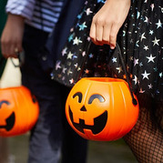 students holding trick or treat baskets