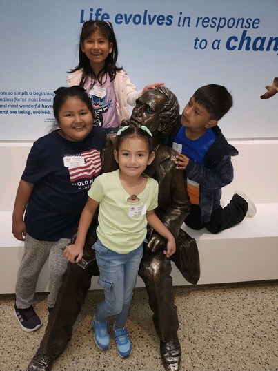 Students smiling at the natural history museum 