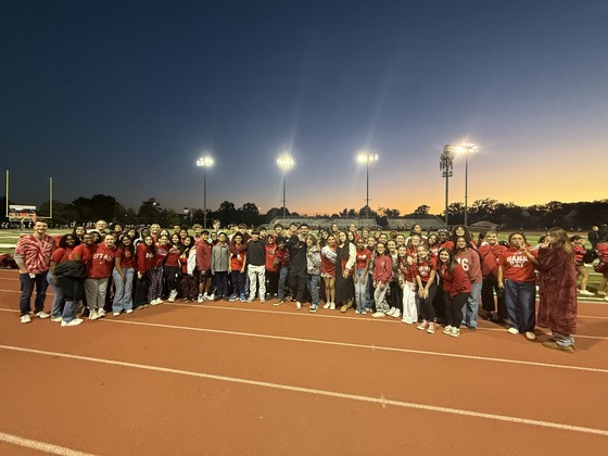 Chorus students standing on the track