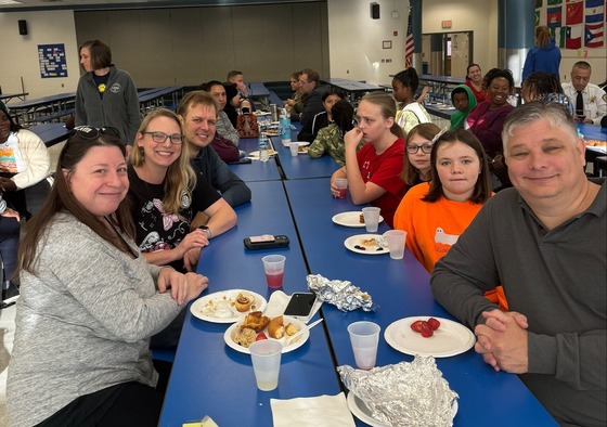 parents and students eating breakfast together at school