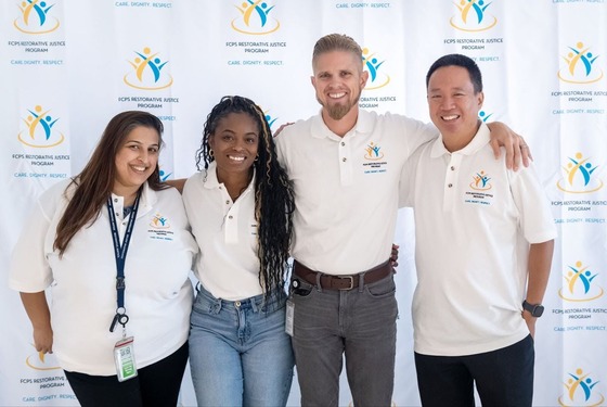 staff posing for a photo together and smiling