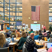 Dr. Reid speaking in front of a crowded room