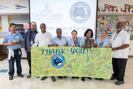 custodial staff smile for a photo