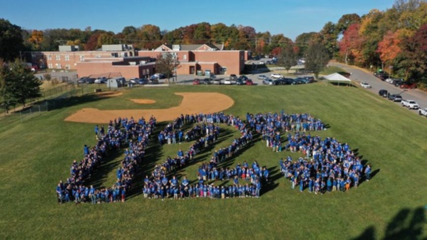 students spell out the number 125 for a birds eye photo