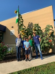 students smiling next to their new green flag