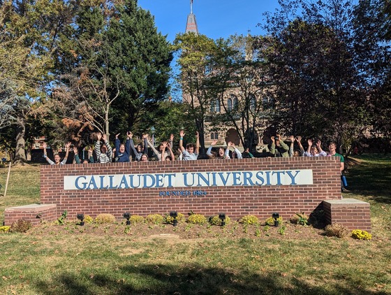 Students behind the Gallaudet University sign