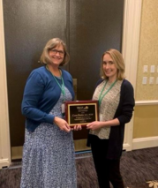 employee receives an award plaque