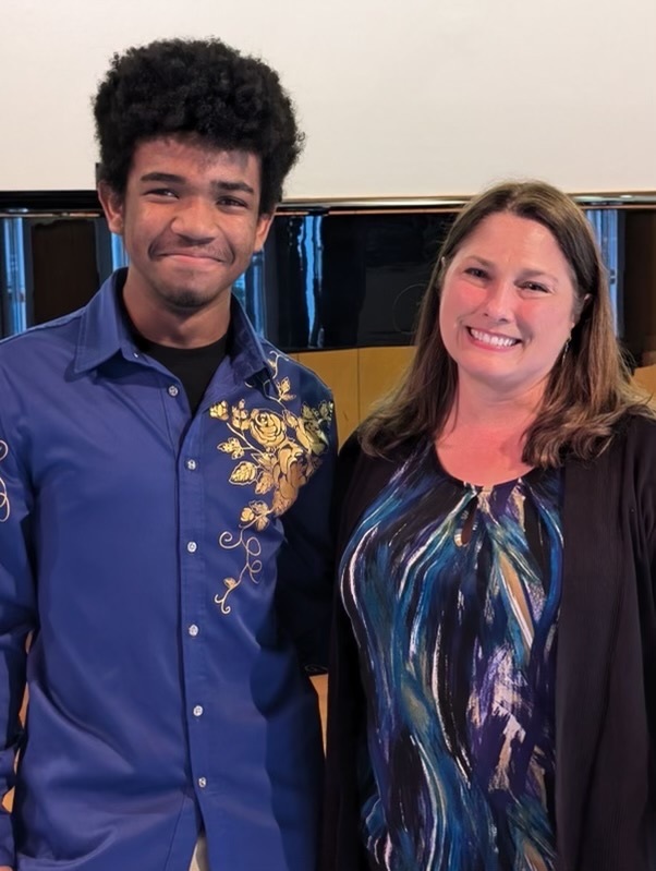 a student and adult smiling for a photo