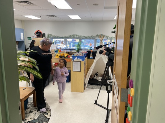 A teacher and child are pictured while the FCPS video crew films. 