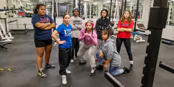 girls wrestling team smiling for a photo