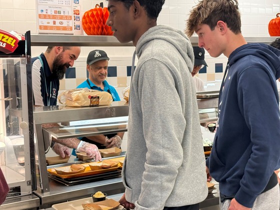 Mr. Peters serving students Thanksgiving lunch