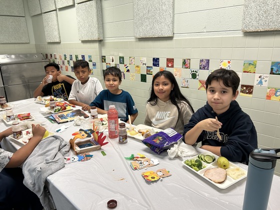 Students gather around the table