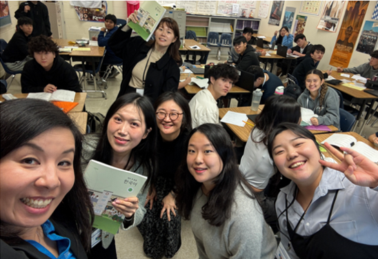 Korean teachers and coordinators in classroom standing together