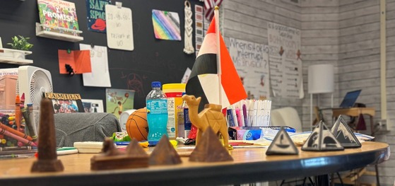 Egyptian artifacts and imagery on a teacher's desk