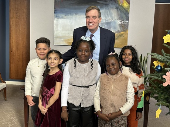 Senator Warner posing in his office with students