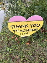 A heart sign in the grass that says thank you teachers and staff