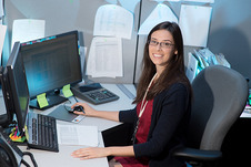 An FCPS student at a desk participating in an internship.