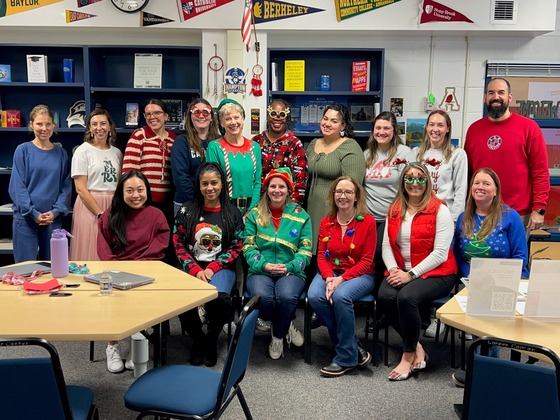 Student Services Department pose for group picture in their holiday attire