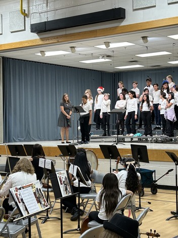 A student introduces the chorus song. 