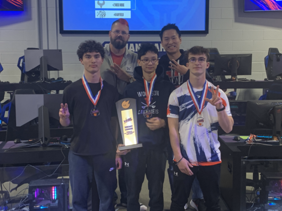 Esports Rocket League team wins Championship and poses with trophy