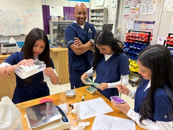 Pharmacy teacher and students making slime