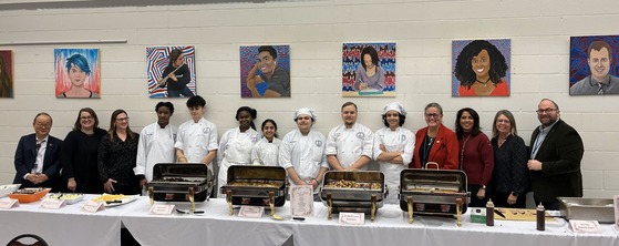 Photo of school board members with Marshall Academy culinary students at Joint Dinner with Fairfax City School Board