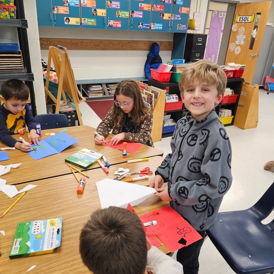 Members of Clermont's Military Kids Club make cards for service-members overseas.