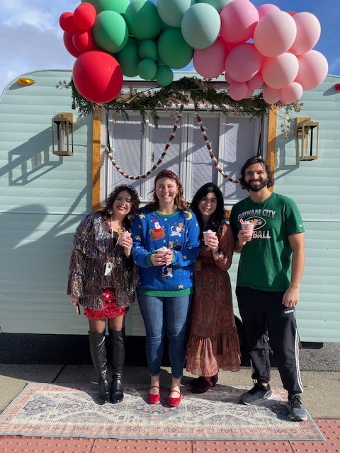 Clermont staff enjoy hot cocoa in front of the hot cocoa truck. 