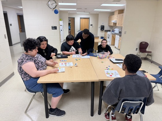 students sitting at a round table playing bingo