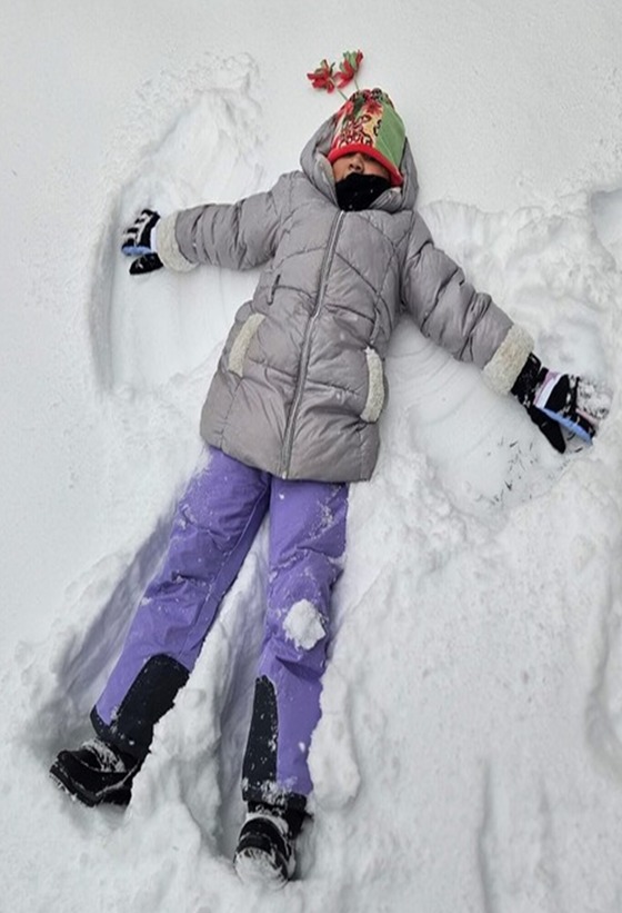 Student playing in the snow