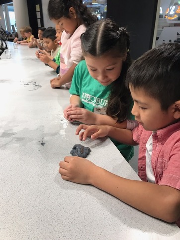 Students making slime at the science center 