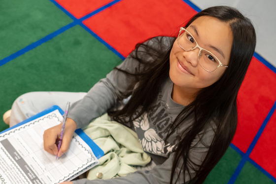 picture of student happily working in class