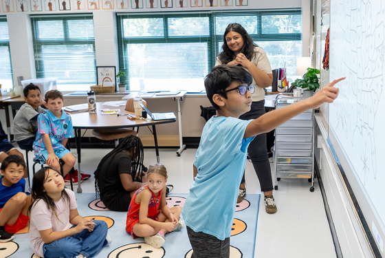 student points to blackboard
