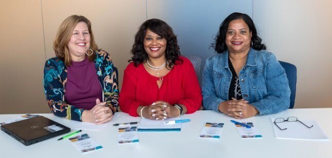 staff smiling while seated
