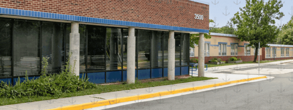 Newsletter banner is an image of the school in the background with a layer of anchors on top with the letters of navy appearing