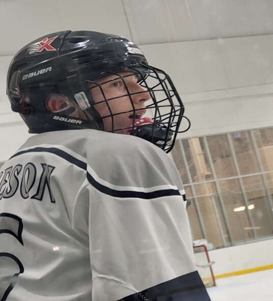 Hockey player  looks on as the team makes one last goal