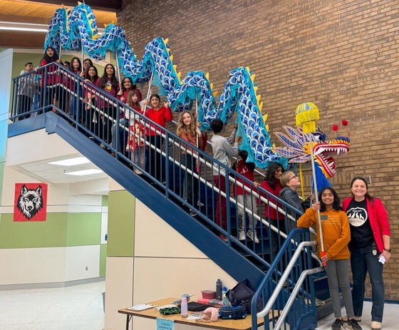 Oak Hill blue dragon with 6th grade students on the grand staircase