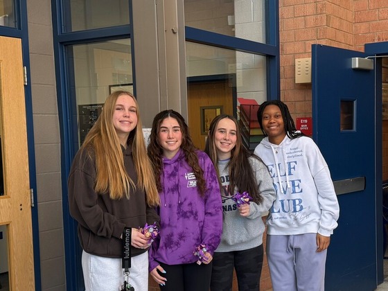 students welcoming other students in to the building