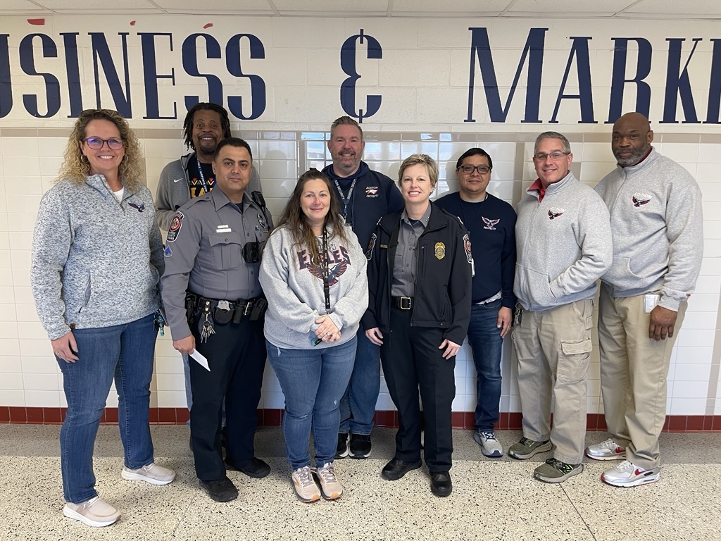 adults standing in the hallway of a school