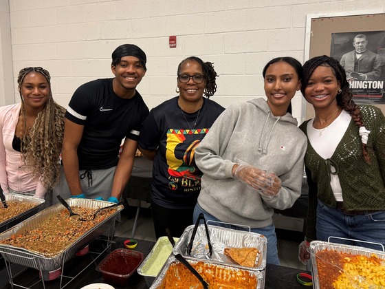 students and staff smile while at the Black History Month Lunch and Learn