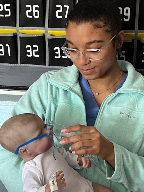 Student giving nebulizer treatment