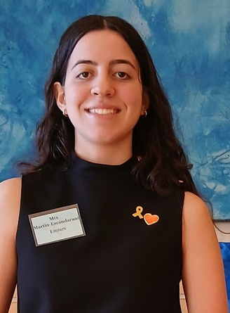 a girl smiling wearing a black shirt with a nametag