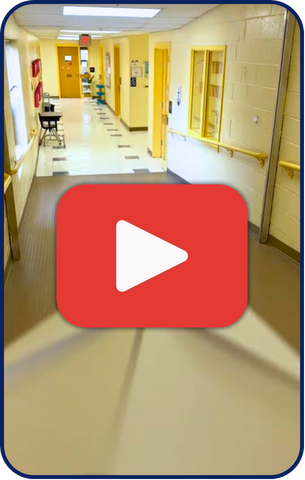 Play button on top of image of recent reel of a paper airplane flying through the school halls