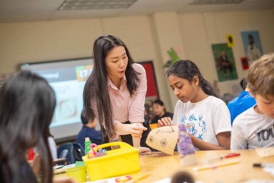 teacher works on project with student