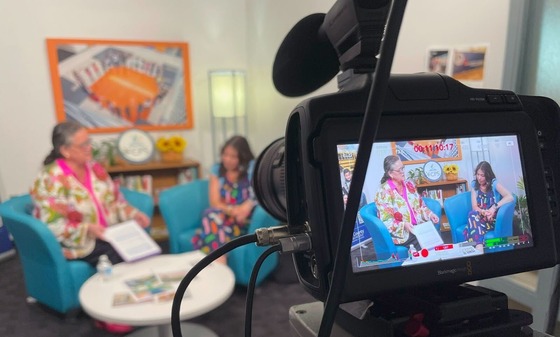 Dr. Reid speaks with a student for a podcast