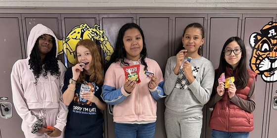 students standing in front of lockers smiling
