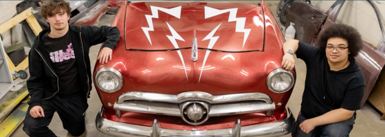 2 students on either side of a car