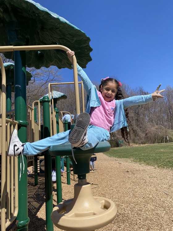 A first grader enjoys the sunny weather outside 