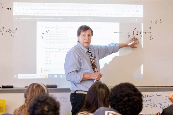 Math teacher points at the board during class